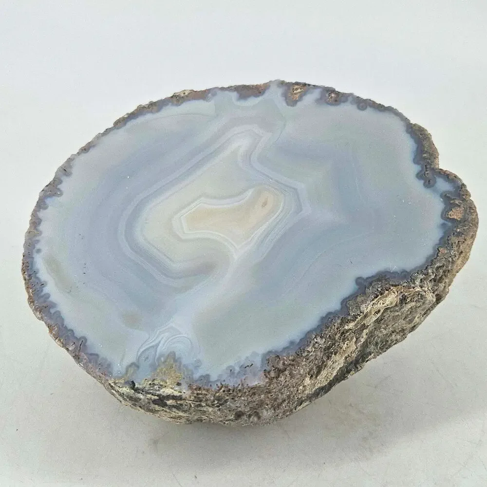 Raw Brazilian polished translucent blue grey agate geode